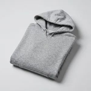 A grey hoodie folded neatly on a pale surface.