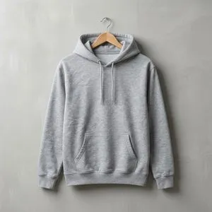 A grey hoodie on a wooden hanger against a concrete wall.
